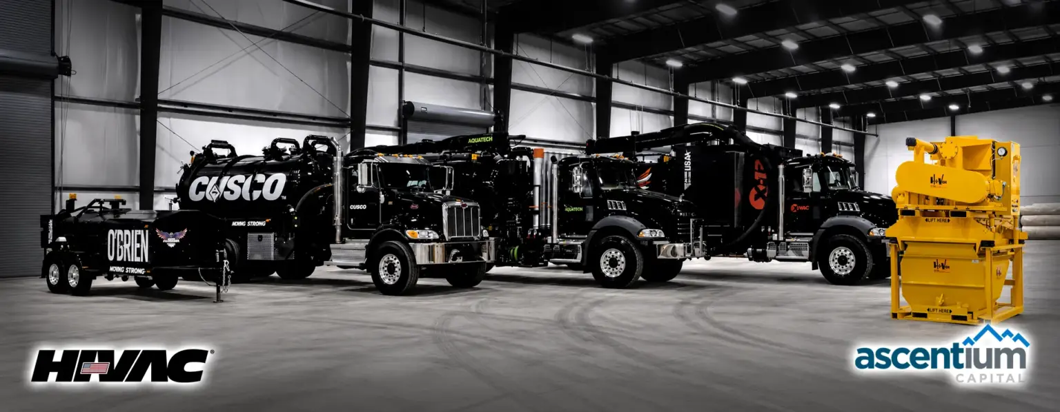 Cusco vacuum trucks lined up in the Hi-Vac facility, with the Ascentium Capital financing logo